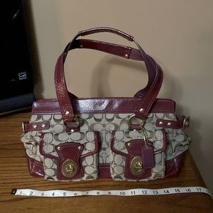 Coach satchel with burgundy trim and 2 outside pockets